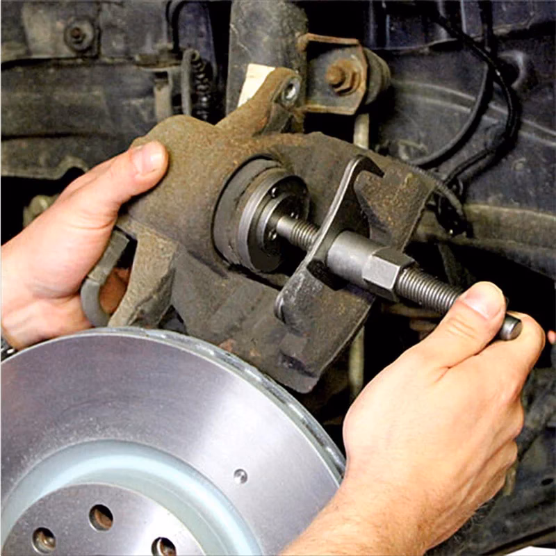 What is the purpose of a brake caliper tool?