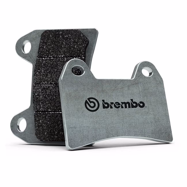 How do carbon fiber ceramic compound pads improve braking?