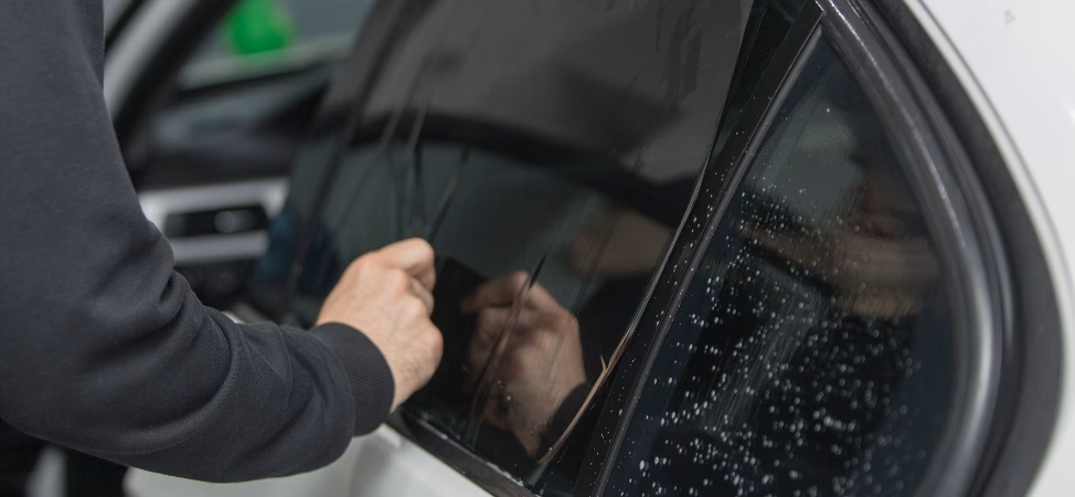 How do you remove bubbles from window tint?