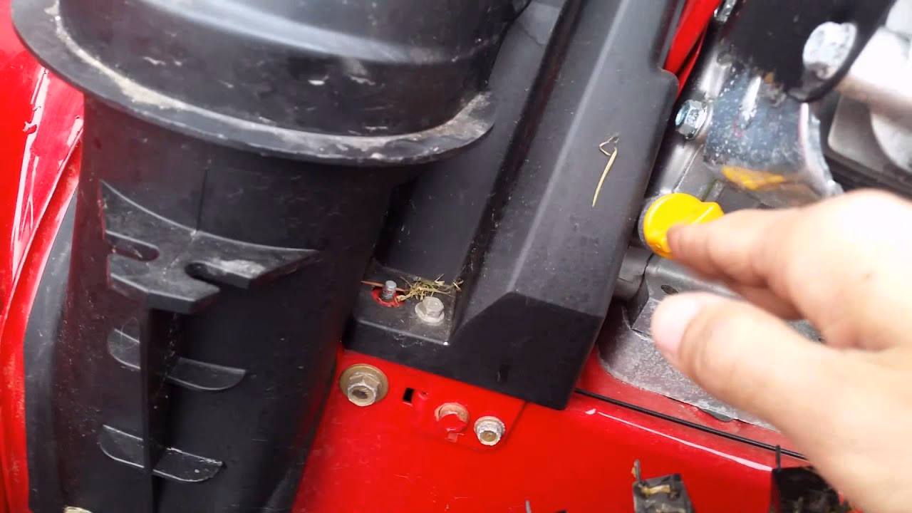 How do you remove oil from a Troy Bilt snowblower?