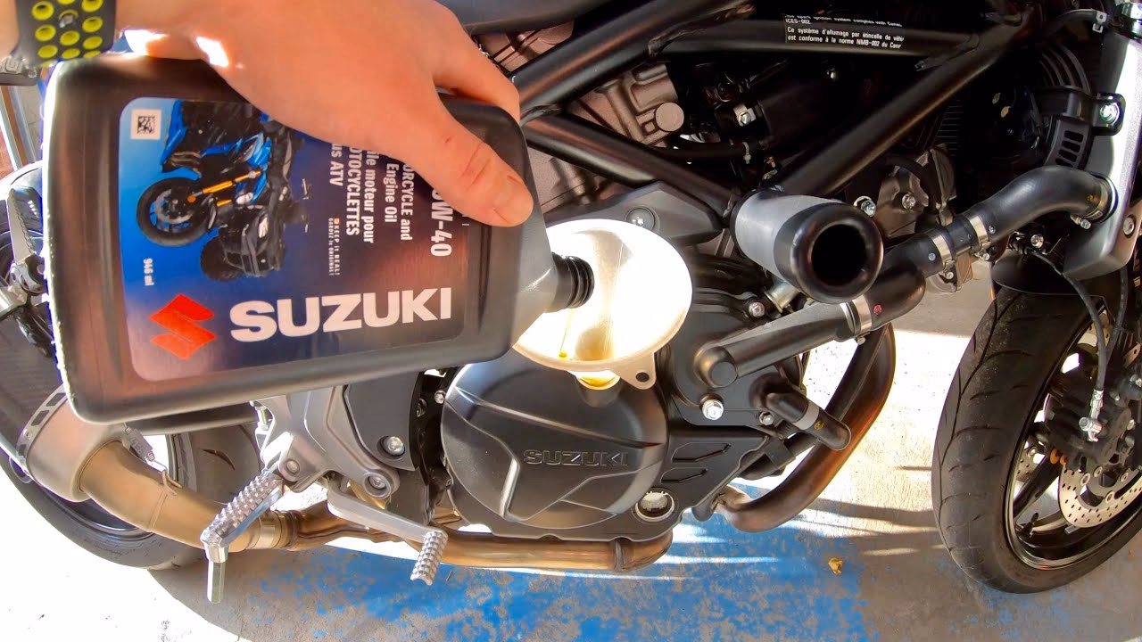 How do you drain oil from a Suzuki SV650 engine?