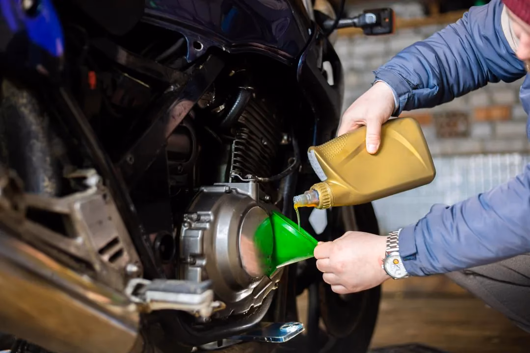 How do you remove engine oil from a bike?
