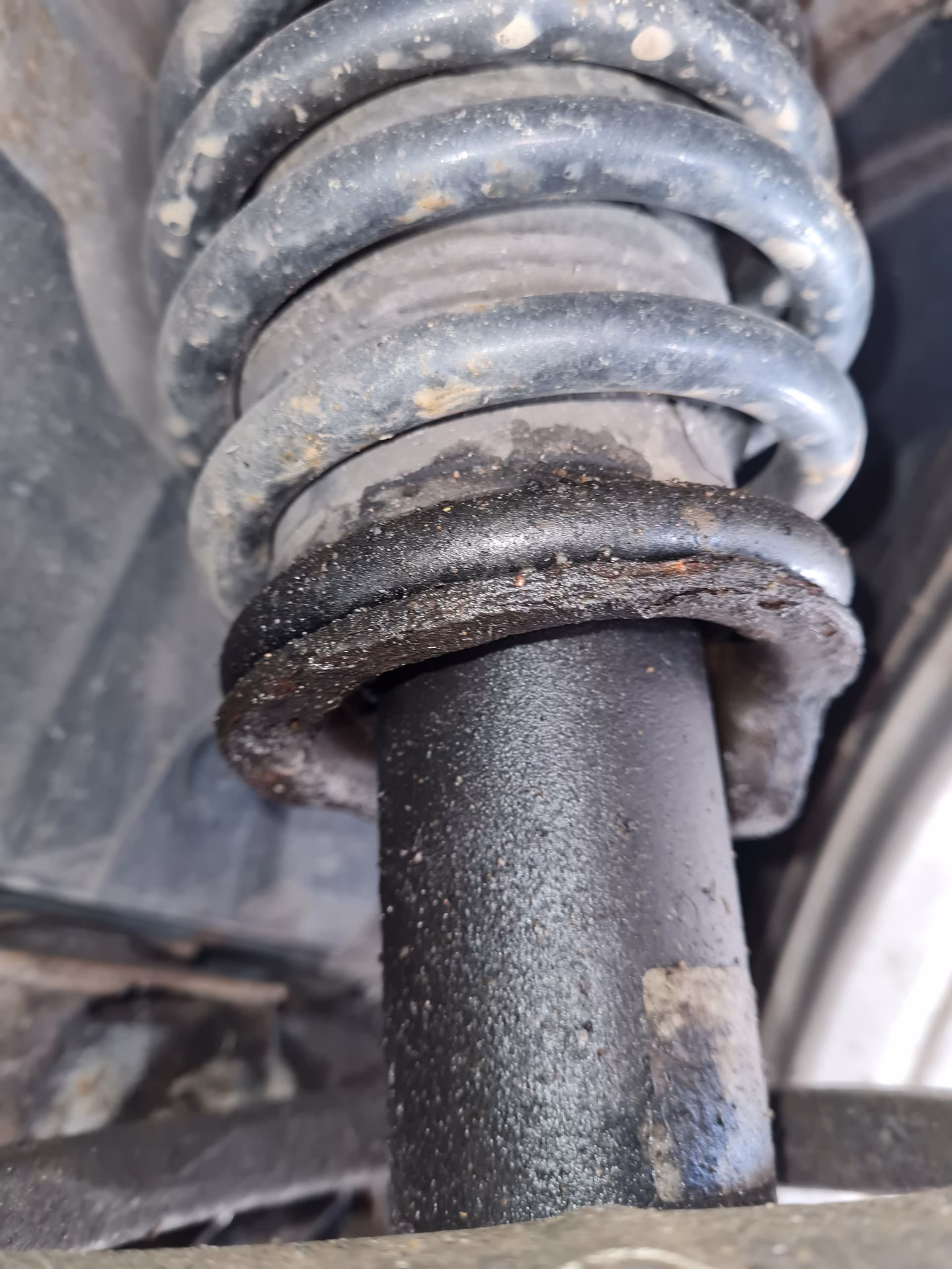 What causes a shock absorber dust cover MOT to fail?