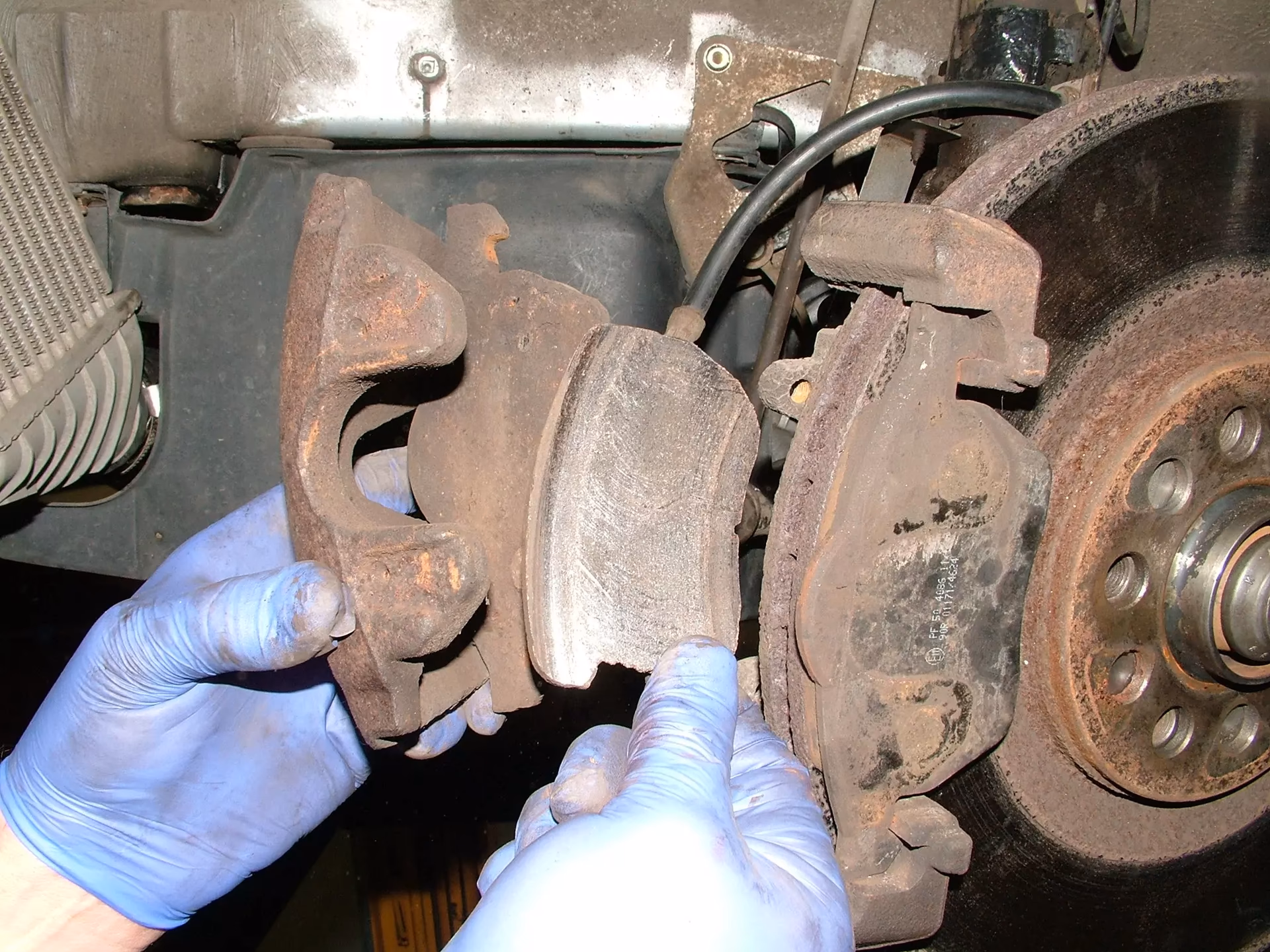 How do you know if a brake caliper is frozen?