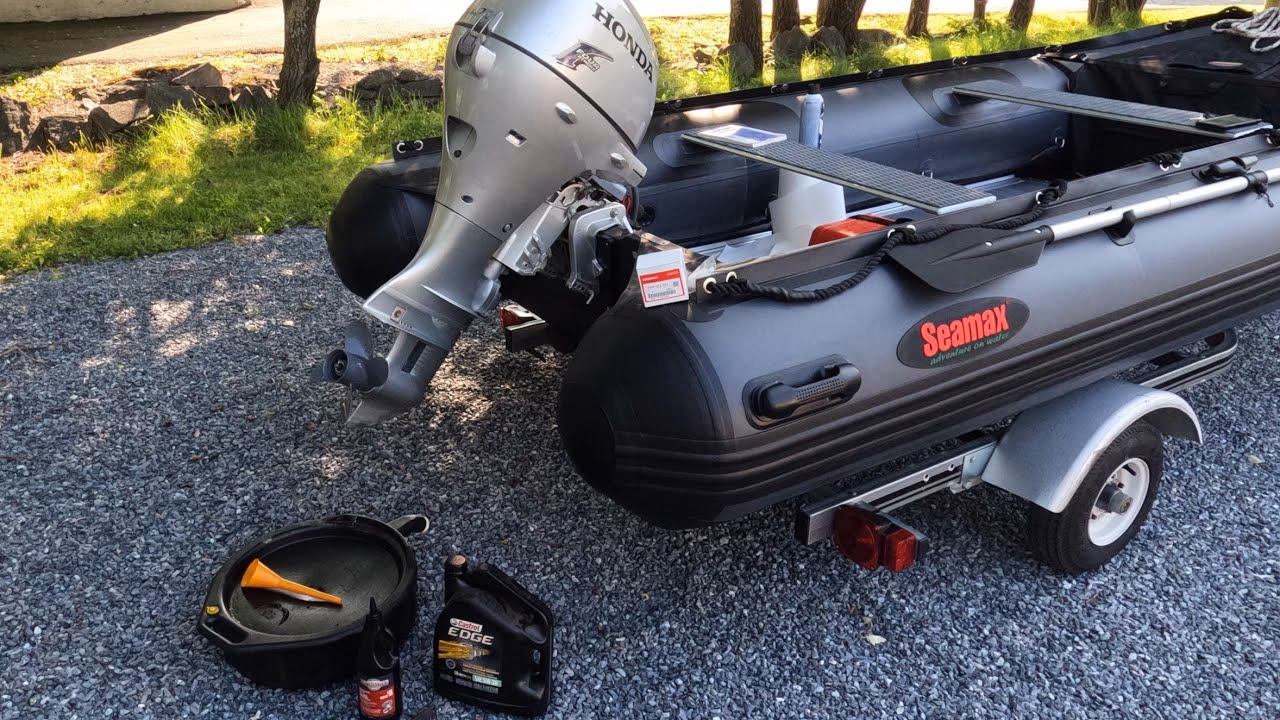 How do I change the oil in my outboard motor?