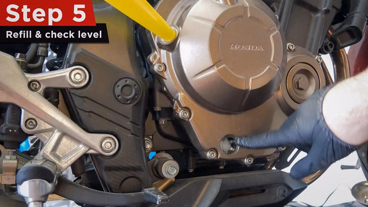How do you drain oil on a Honda CB500F?