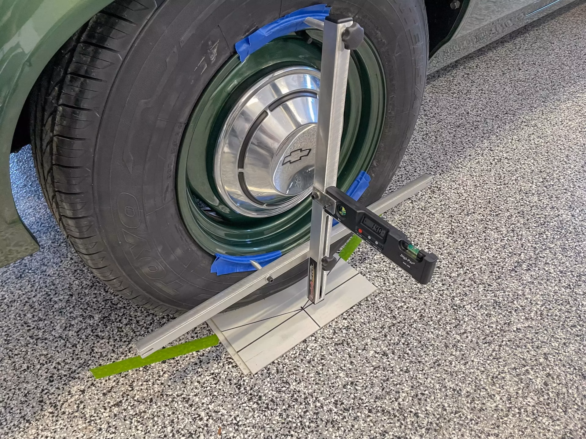 What is the first step in a wheel alignment?