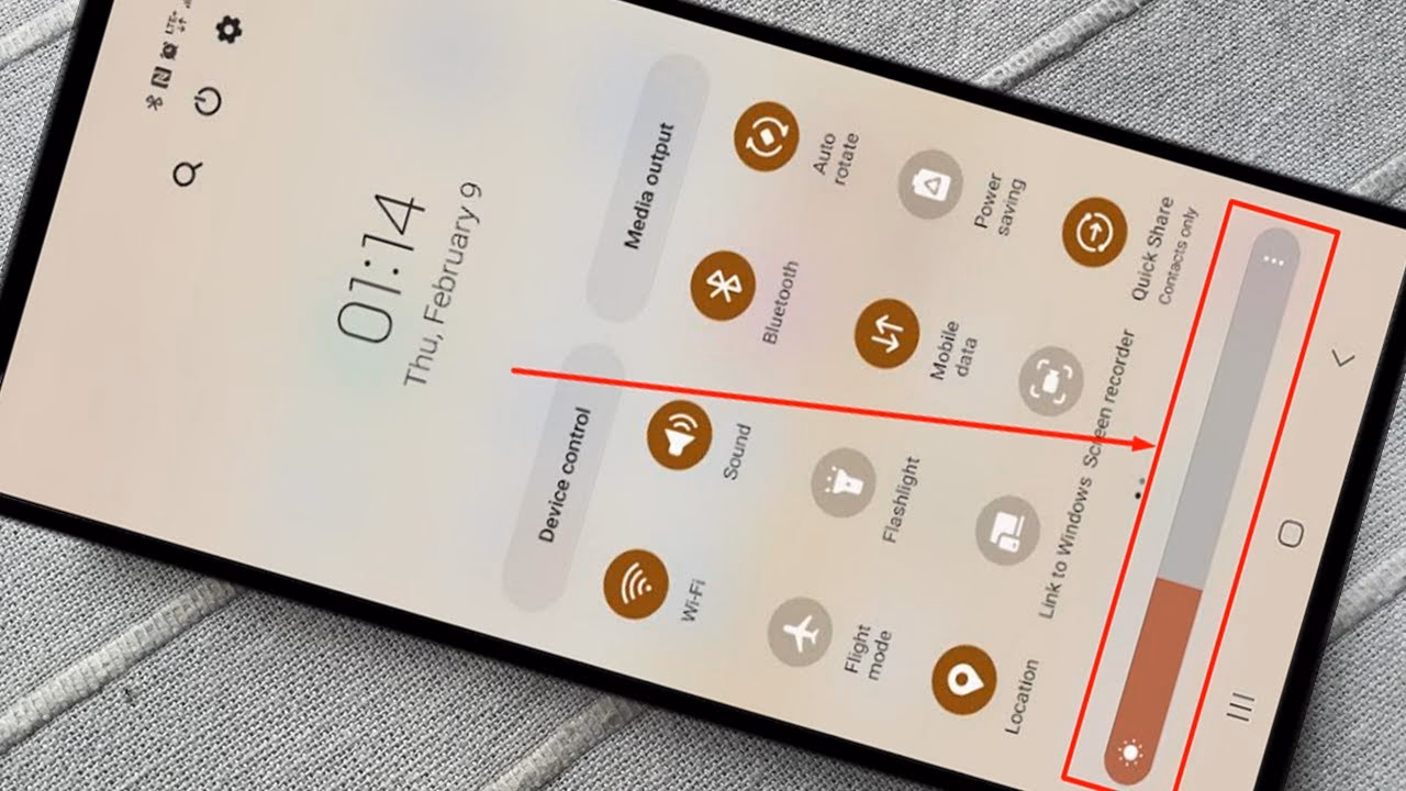How do iOS devices adjust brightness?