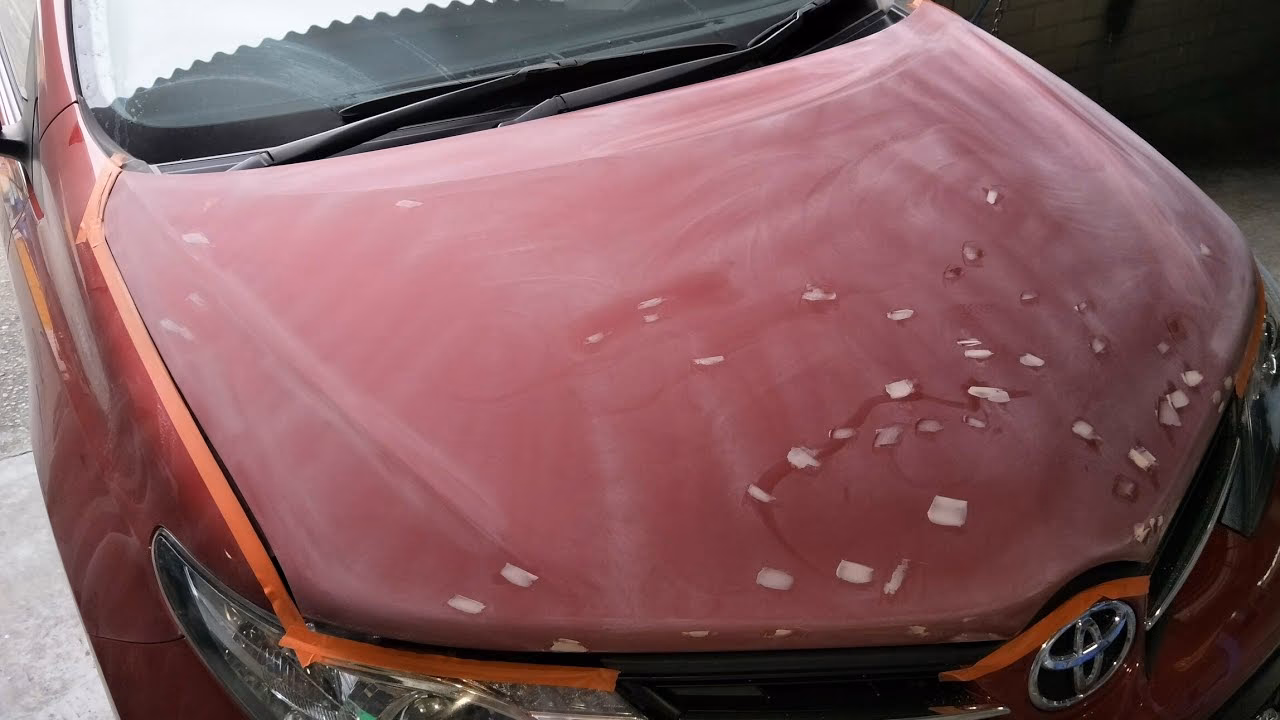What causes paint chips on a car hood?