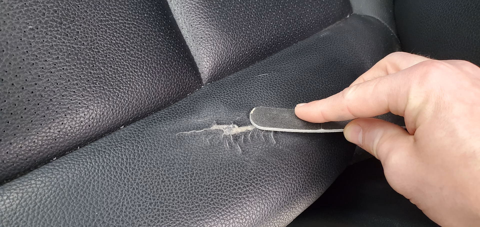 How to check for rips or tears in a car seat?
