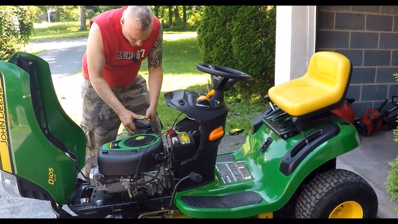 How to remove the oil drain cap on a John Deere E110?