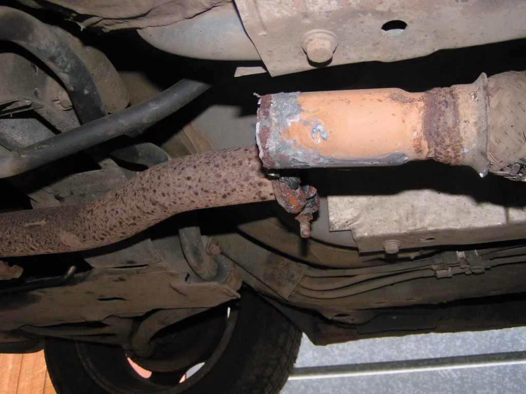 How do you fix a low hanging exhaust pipe?