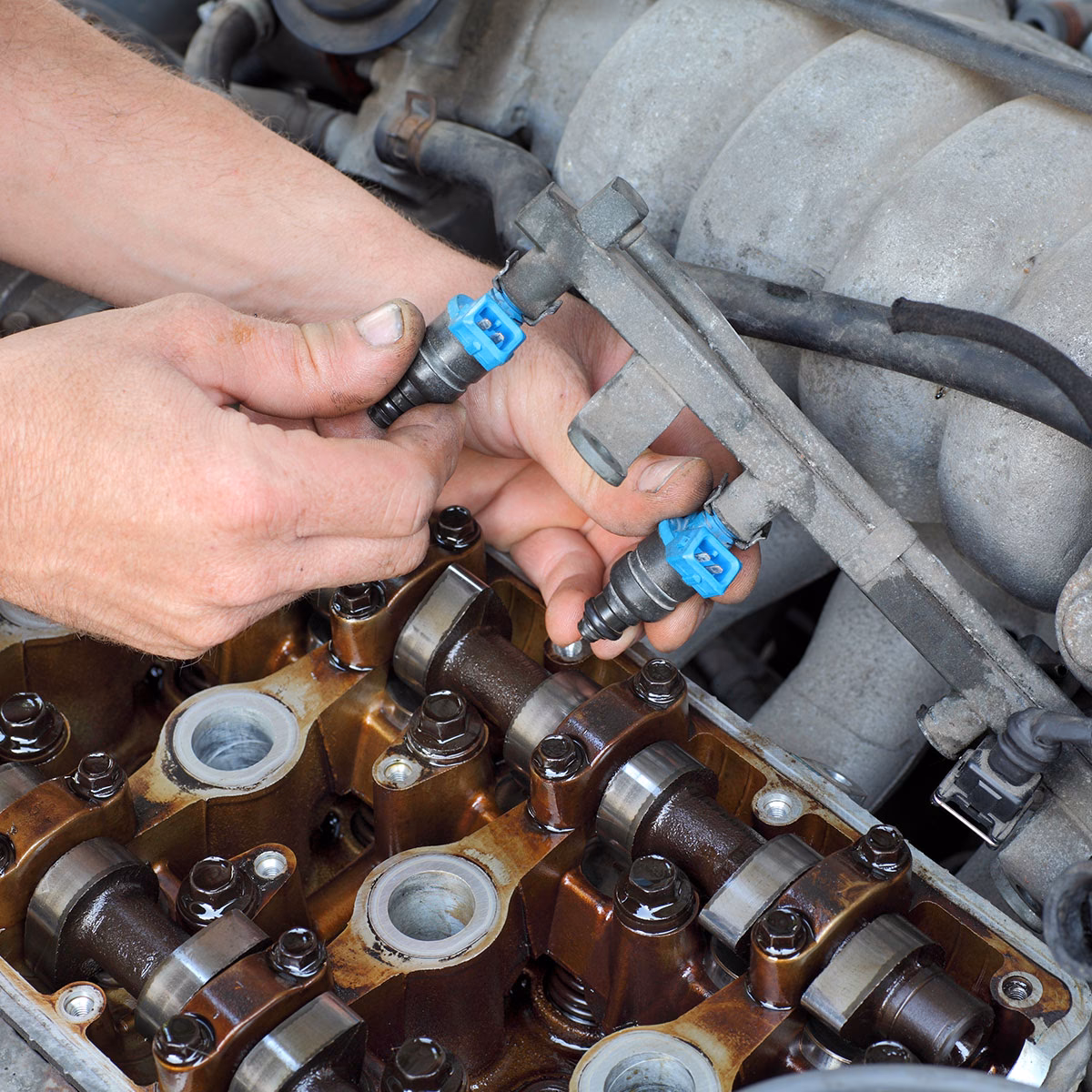 How do I replace a Mazda fuel injector?