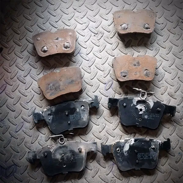 Why do brake pads have a backing plate?