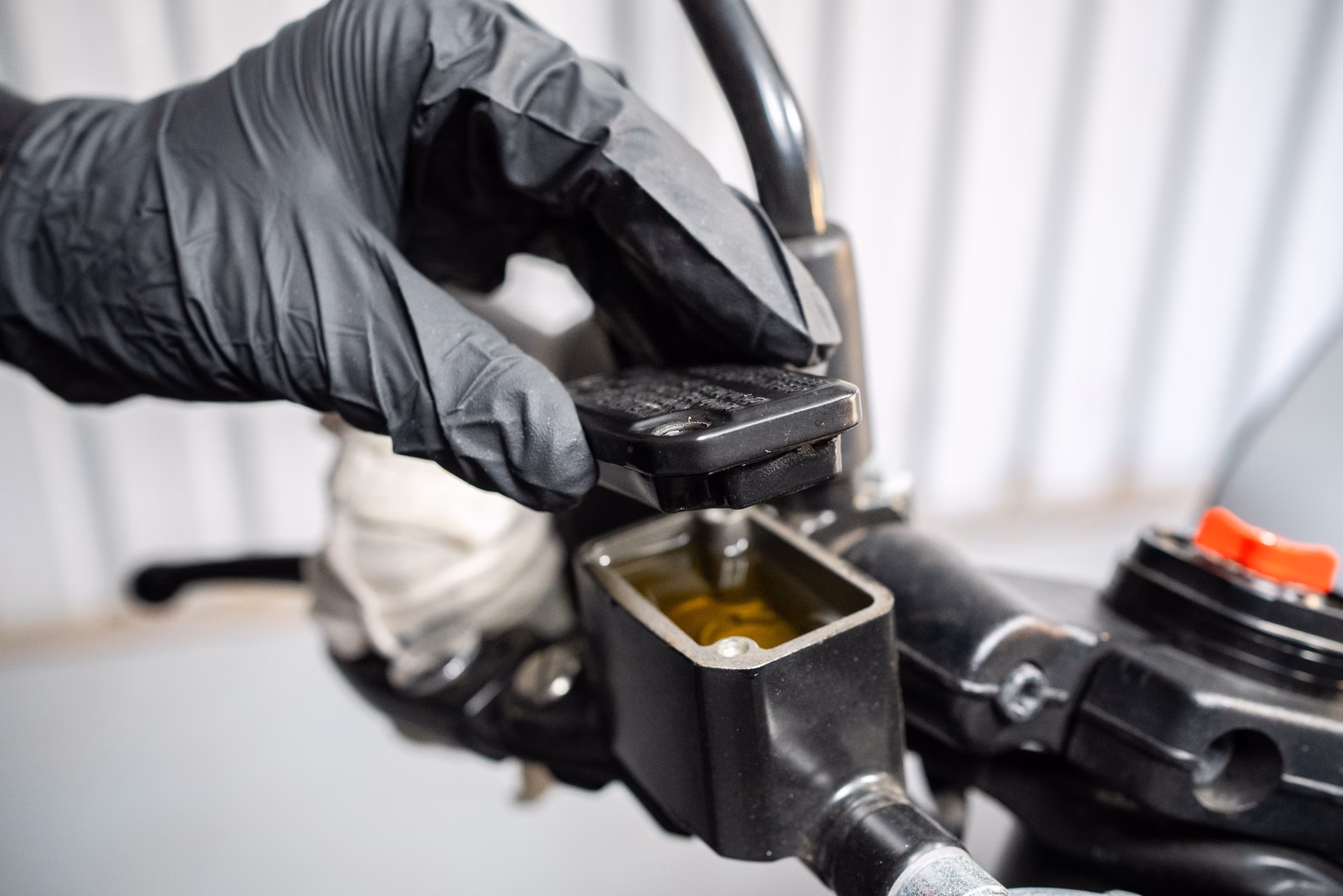 How does brake fluid work on a motorcycle?