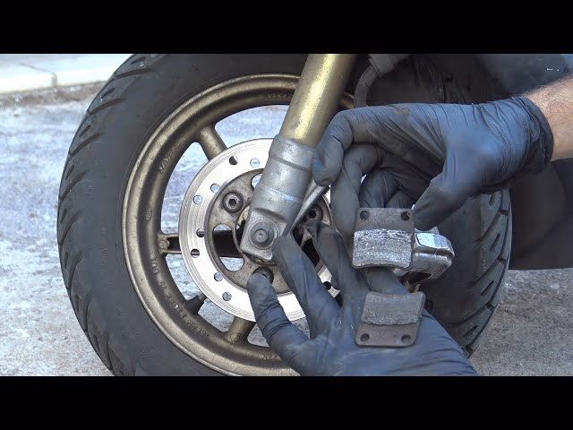 Should a caliper piston be wound back before installing new brake pads?