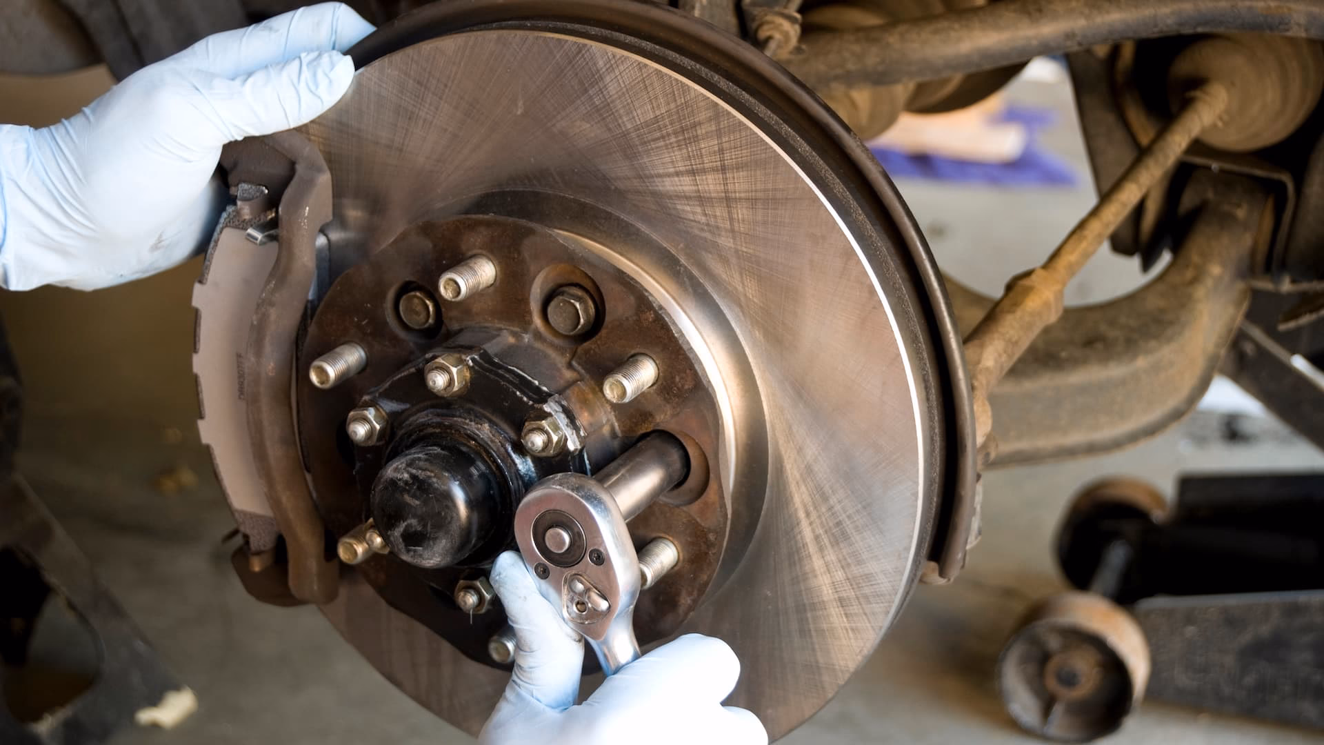 How do you remove a road wheel from a brake disc?