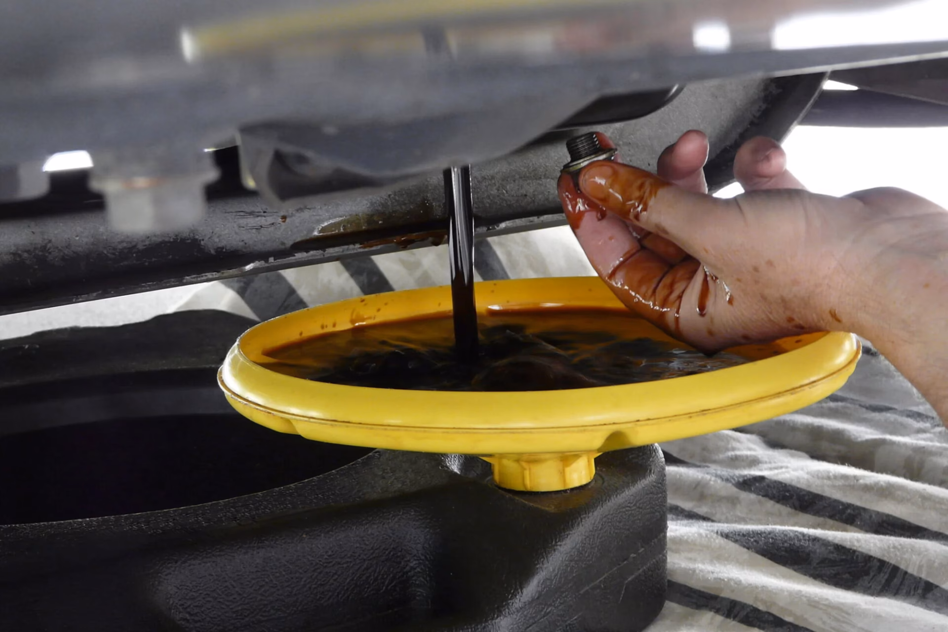 Should you change engine oil hot or cold?