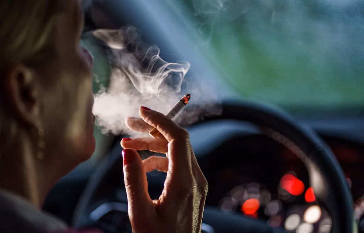 Can a 18 year old smoke in a private car in Scotland?
