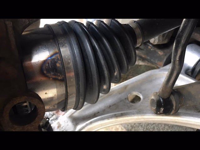 What happens if a strut boot is damaged?