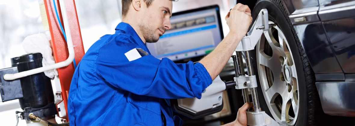 Who performs the professional wheel alignment service at Ultra Tune?