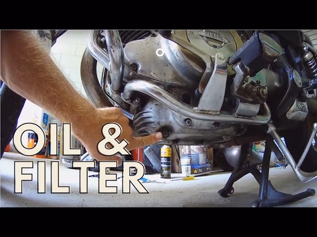 How do you drain oil from a Virago 1100 engine?